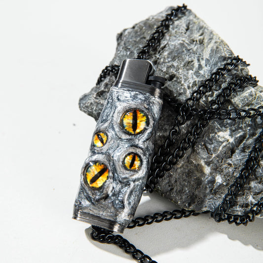 Mellow Sora dragon eye lighter case with black chain on stone background