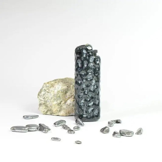Textured black lighter case by Mellow Sora with stones and rock, minimalist white background