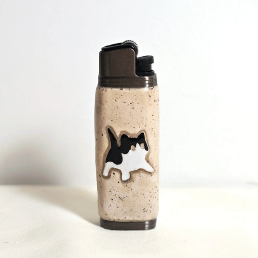Beige lighter case with black and white cat design, Mellow Sora accessory on white background.