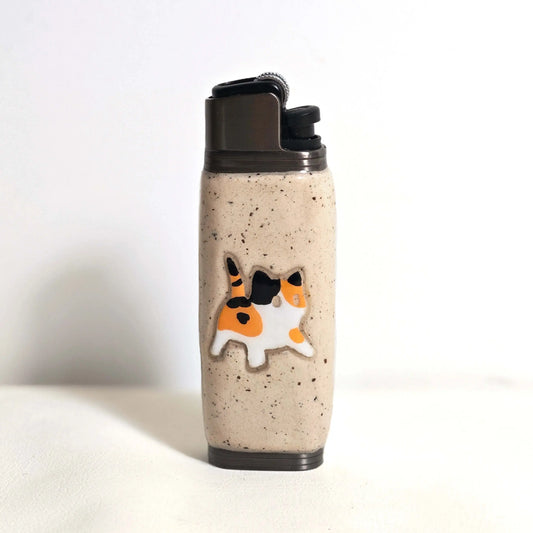 Speckled ceramic lighter case with a cute calico cat design from Mellow Sora