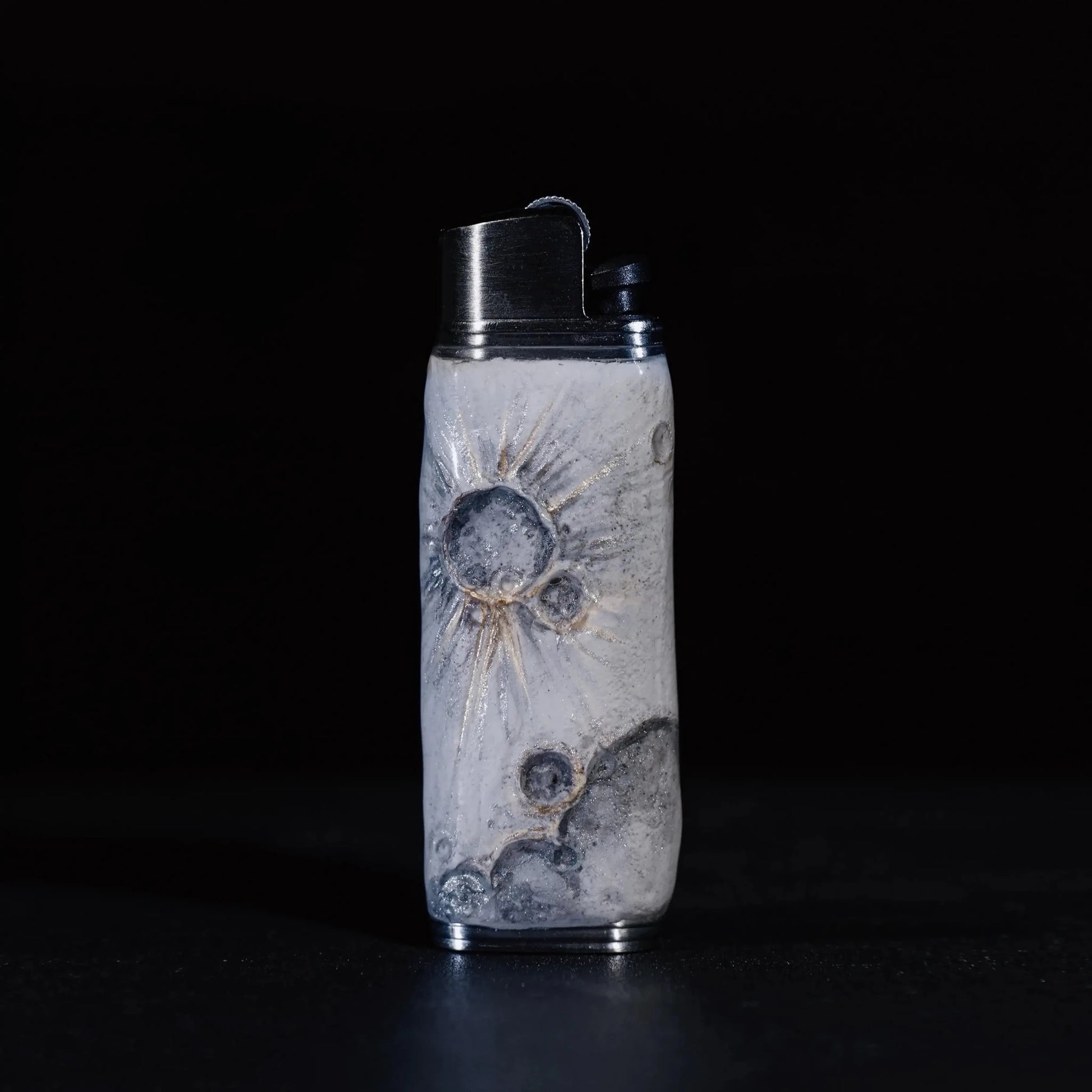 Mellow Sora moon-inspired lighter case with crater designs on a dark background