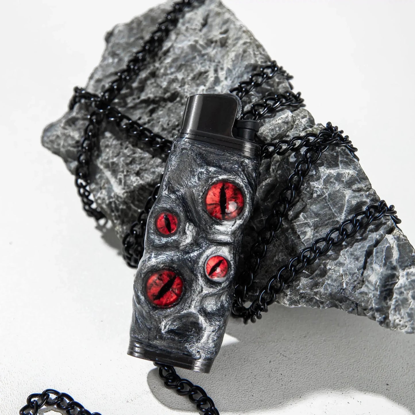 Unique dragon eye lighter case with red accents on black rock and chain, Mellow Sora accessory