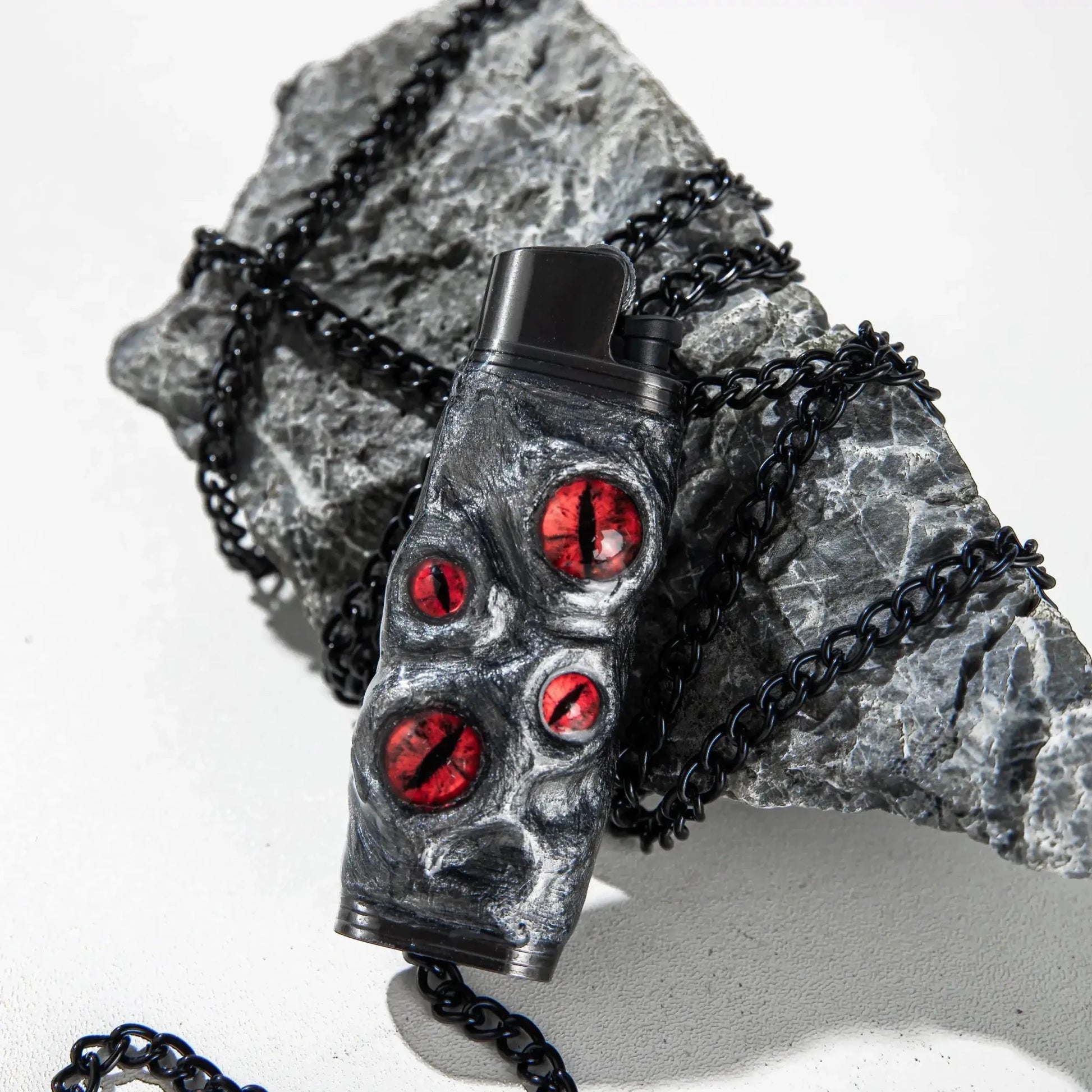 Unique dragon eye lighter case with red accents on black rock and chain, Mellow Sora accessory