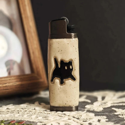 Ceramic lighter case with black cat design on lace table, Mellow Sora lifestyle accessory