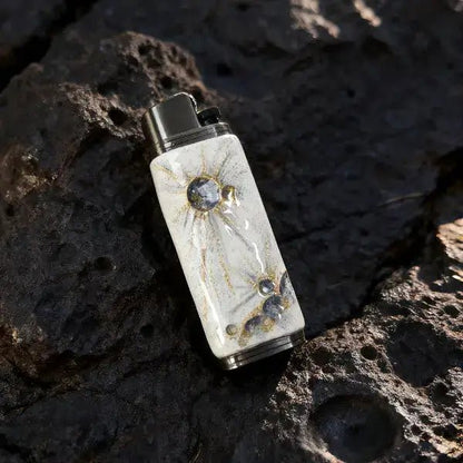 Artistic white and gold lighter case with spark design on stone, Mellow Sora accessory