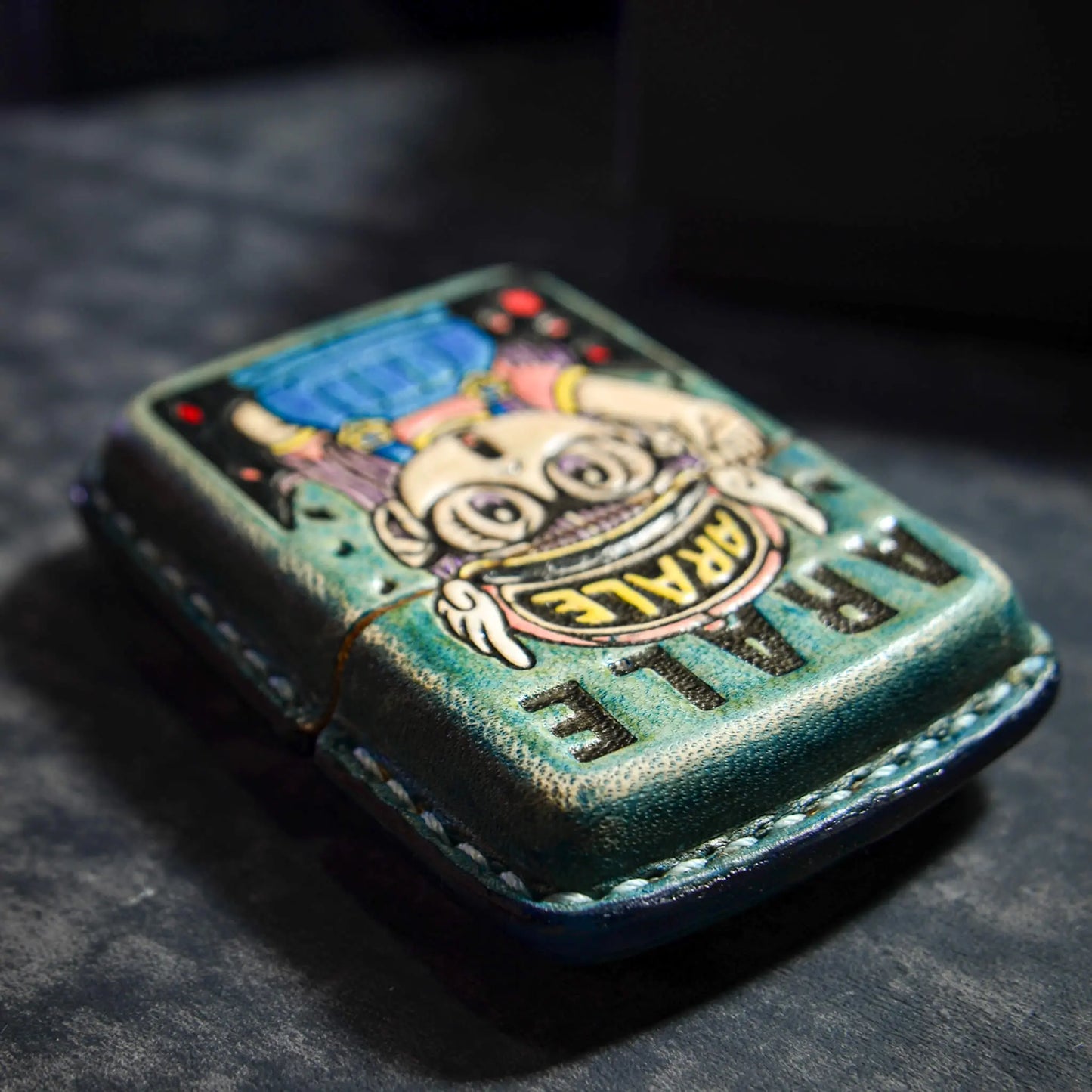 Colorful hand-stitched Mellow Sora lighter case with cartoon Artale design on textured surface